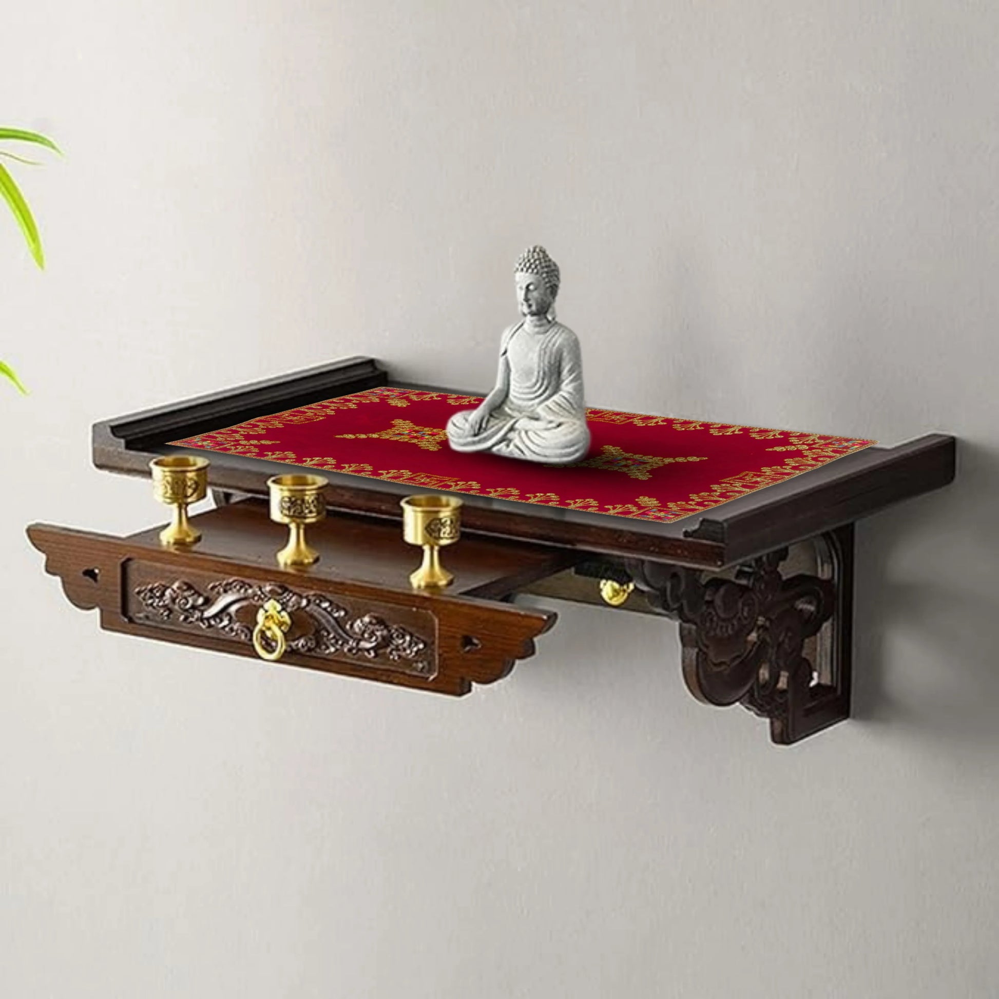 Decorative wall shelf with Buddha statue and candles on a plain background