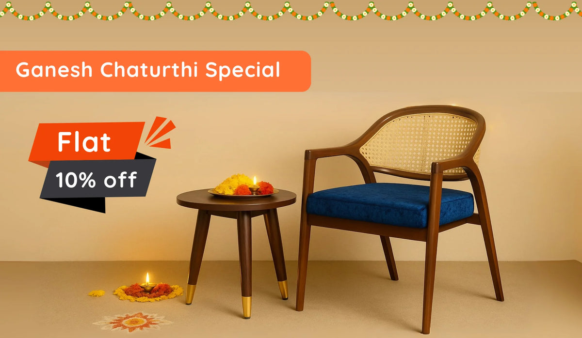 Ganesh Chaturthi special banner: teak cane-back armchair with blue cushion, round side table, rangoli & diya, highlighting flat 10 % off.