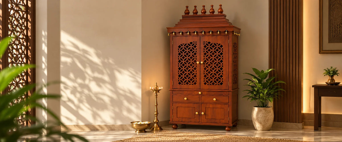 Teak pooja mandir with jali doors in the corner of a room